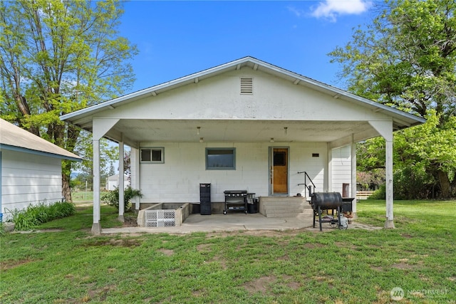 705 Old Kettle Rd, Kettle Falls, WA 99141 - rear view of house with a lawn and a patio