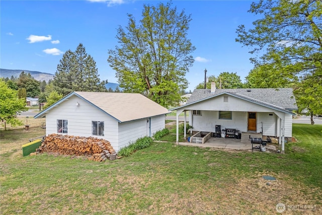 705 Old Kettle Rd, Kettle Falls, WA 99141 - back of house featuring a patio and a lawn