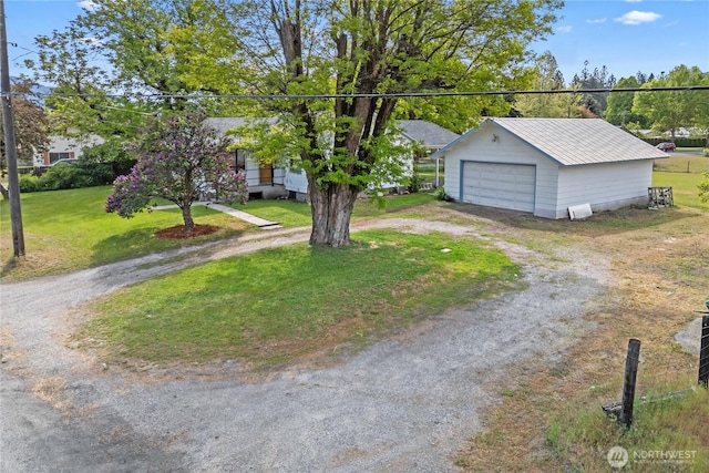 705 Old Kettle Rd, Kettle Falls, WA 99141 - view of front facade with a garage, an outdoor structure, a front yard, metal roof, and driveway