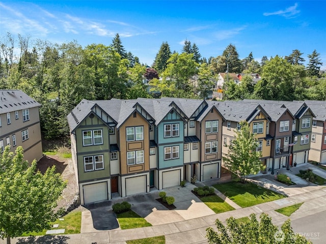 7165 27th Ave SW, Seattle, WA 98106 - multi unit property with driveway, a residential view, an attached garage, and board and batten siding