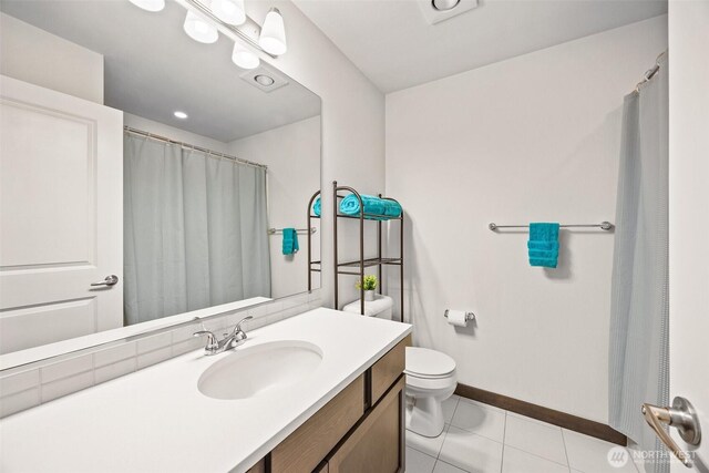 7165 27th Ave SW, Seattle, WA 98106 - full bath featuring toilet, baseboards, vanity, curtained shower, and tile patterned floors