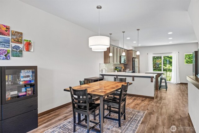 7165 27th Ave SW, Seattle, WA 98106 - dining room featuring wood finished floors, recessed lighting, and baseboards