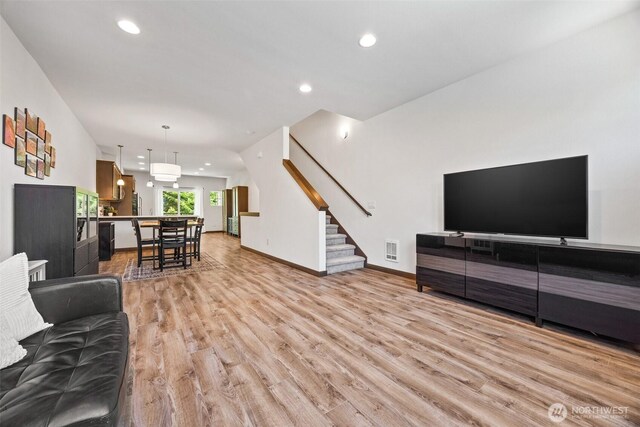 7165 27th Ave SW, Seattle, WA 98106 - living room featuring light wood-style flooring, stairway, recessed lighting, and baseboards