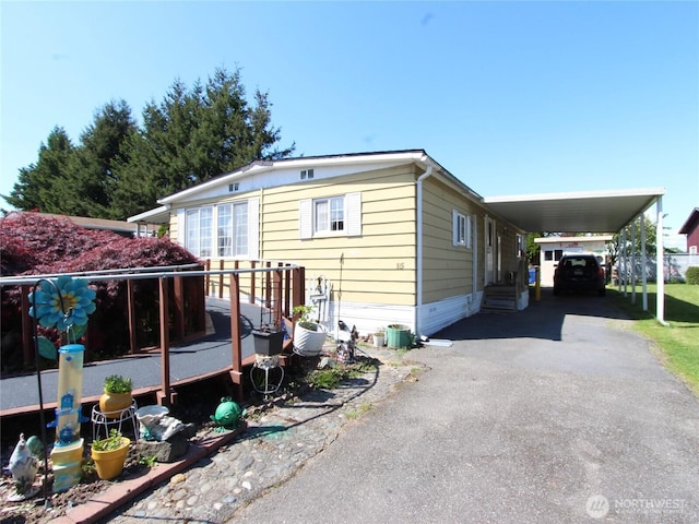 920 Maple Ln Unit 15, Sedro Woolley, WA 98284 - view of front of property with asphalt driveway, a carport, and a deck