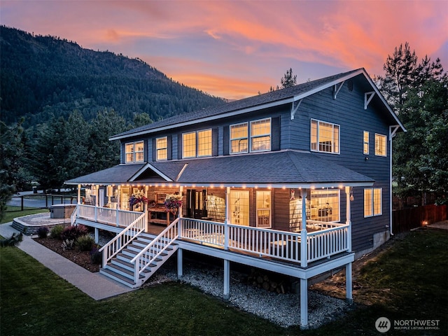 10303 Ski Hill Dr, Leavenworth, WA 98826 - back of property featuring covered porch, a mountain view, and a shingled roof