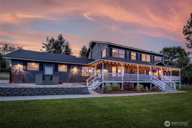 10303 Ski Hill Dr, Leavenworth, WA 98826 - rear view of house with a hot tub, a yard, a porch, and stairs