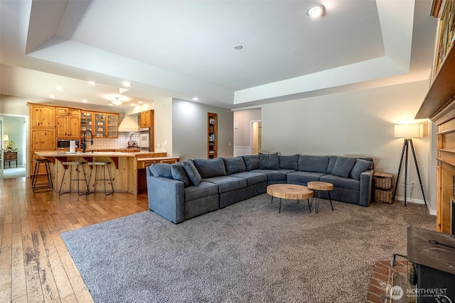 10303 Ski Hill Dr, Leavenworth, WA 98826 - living room with a tray ceiling, recessed lighting, and light wood finished floors