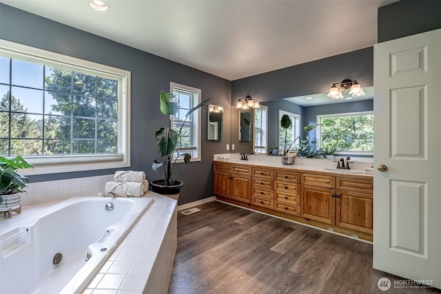 10303 Ski Hill Dr, Leavenworth, WA 98826 - bathroom featuring double vanity, wood finished floors, healthy amount of natural light, a whirlpool tub, and recessed lighting