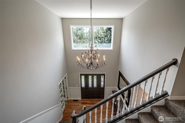10303 Ski Hill Dr, Leavenworth, WA 98826 - foyer with a chandelier, wood finished floors, stairs, a towering ceiling, and french doors