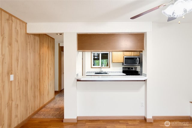 7581 Old Redmond Rd # 4, Redmond, WA 98052 - kitchen with appliances with stainless steel finishes, light wood-style flooring, light countertops, and a sink