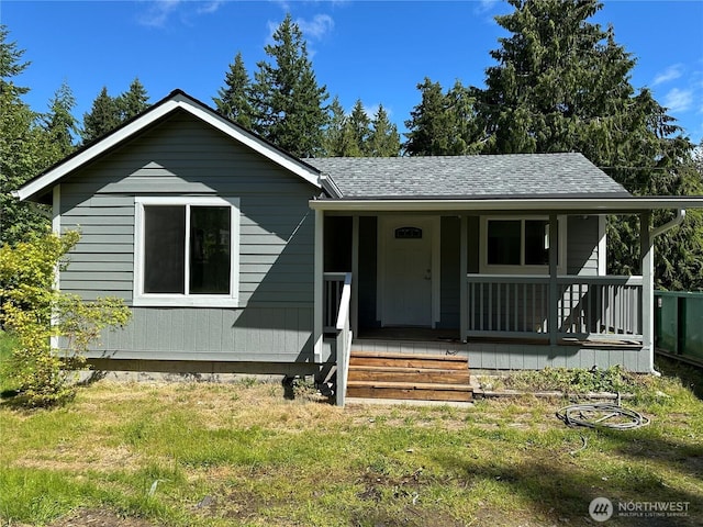 7041 E Washington St, Port Orchard, WA 98366 - view of front of house with roof with shingles, covered porch, and a front lawn