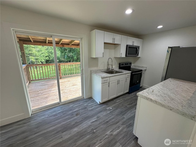 7041 E Washington St, Port Orchard, WA 98366 - kitchen with appliances with stainless steel finishes, a sink, white cabinetry, dark wood-style flooring, and recessed lighting