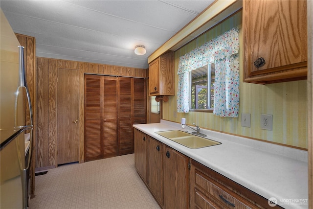 1700 E Shelton Springs Rd Unit 25, Shelton, WA 98584 - kitchen with a sink, freestanding refrigerator, light countertops, and brown cabinets