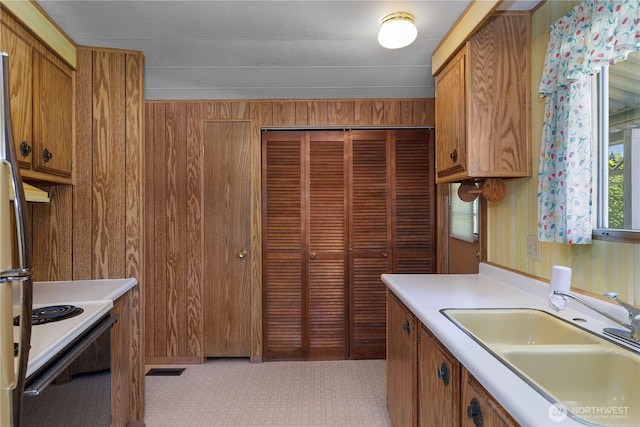 1700 E Shelton Springs Rd Unit 25, Shelton, WA 98584 - kitchen featuring a sink, brown cabinetry, light countertops, and freestanding refrigerator