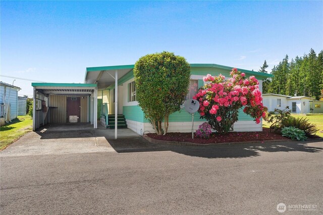 1700 E Shelton Springs Rd Unit 25, Shelton, WA 98584 - manufactured / mobile home featuring entry steps, driveway, and an attached carport