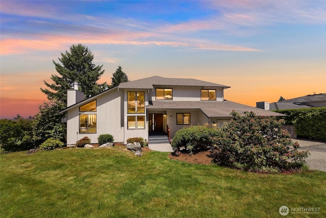 5030 155th Pl SE, Bellevue, WA 98006 - view of front facade featuring a chimney, a front lawn, and an attached garage