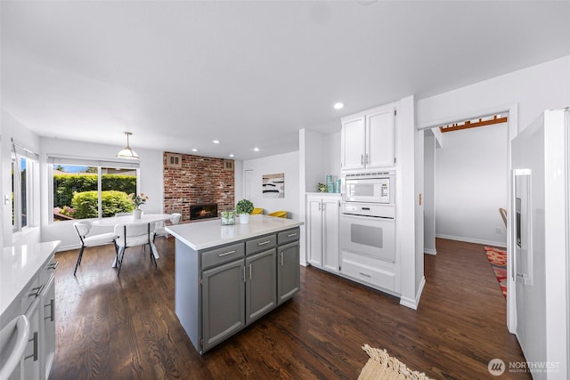 5030 155th Pl SE, Bellevue, WA 98006 - kitchen with white appliances, gray cabinets, light countertops, dark wood finished floors, and recessed lighting