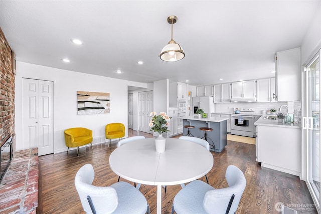 5030 155th Pl SE, Bellevue, WA 98006 - dining area with dark wood finished floors, recessed lighting, and a brick fireplace