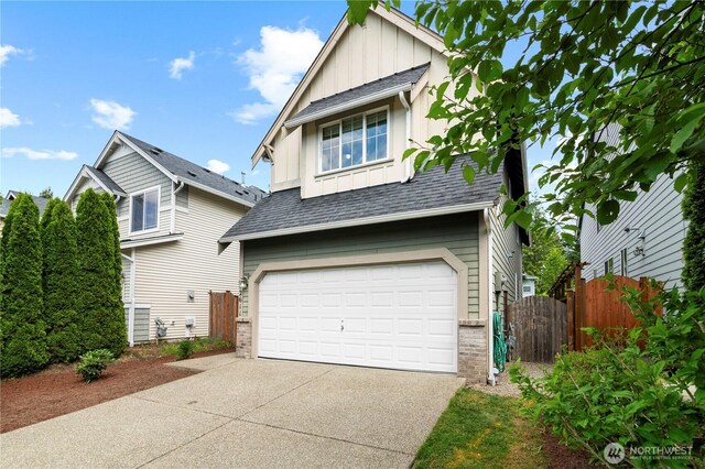 12611 13th Ave SE, Everett, WA 98208 - view of front facade featuring board and batten siding, an attached garage, driveway, and a shingled roof