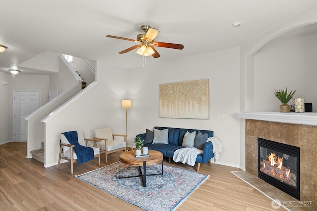 12611 13th Ave SE, Everett, WA 98208 - living room with ceiling fan, stairway, a tiled fireplace, and wood finished floors