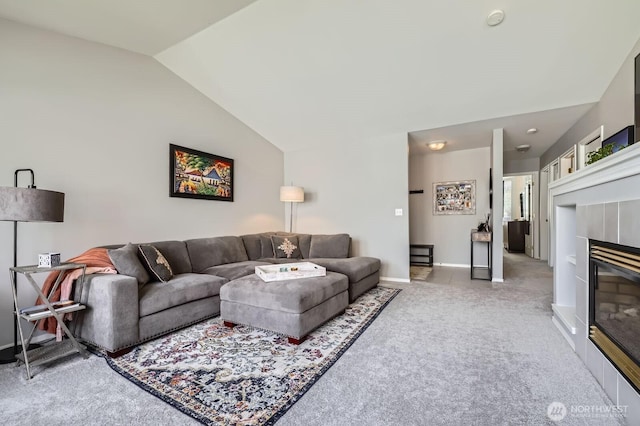800 96th Ave NE Unit G201, Lake Stevens, WA 98258 - living area featuring vaulted ceiling, light carpet, a tiled fireplace, and baseboards