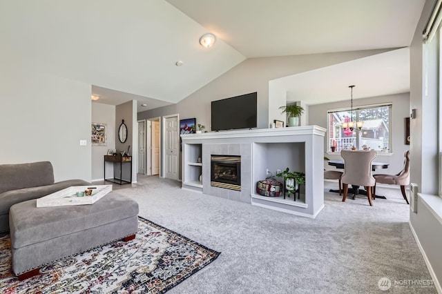 800 96th Ave NE Unit G201, Lake Stevens, WA 98258 - carpeted living room featuring lofted ceiling, a chandelier, a fireplace, and baseboards