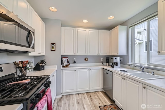 800 96th Ave NE Unit G201, Lake Stevens, WA 98258 - kitchen featuring stainless steel appliances, a sink, tile countertops, white cabinets, and recessed lighting