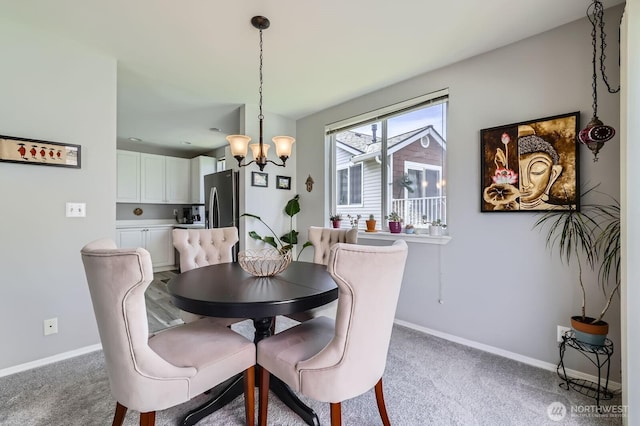 800 96th Ave NE Unit G201, Lake Stevens, WA 98258 - carpeted dining area featuring a chandelier and baseboards