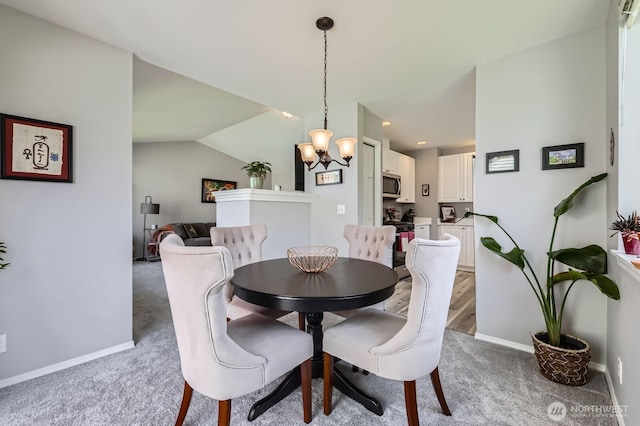 800 96th Ave NE Unit G201, Lake Stevens, WA 98258 - dining space with light carpet, a chandelier, and baseboards