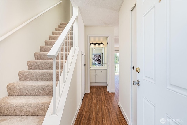 8823 Holly Dr Unit H207, Everett, WA 98208 - stairway with wood finished floors, baseboards, and a textured ceiling