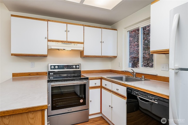 8823 Holly Dr Unit H207, Everett, WA 98208 - kitchen with stainless steel electric range, freestanding refrigerator, under cabinet range hood, dishwasher, and a sink