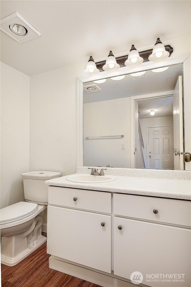 8823 Holly Dr Unit H207, Everett, WA 98208 - bathroom featuring vanity, toilet, and wood finished floors