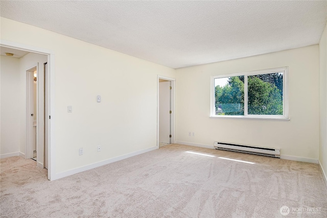 8823 Holly Dr Unit H207, Everett, WA 98208 - carpeted empty room featuring a baseboard heating unit and baseboards
