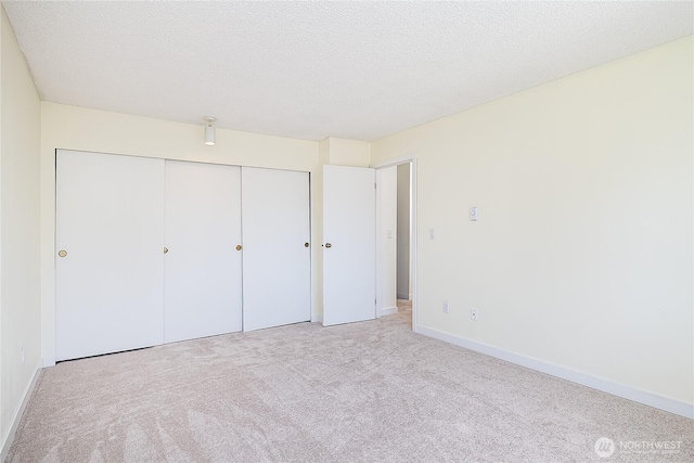 8823 Holly Dr Unit H207, Everett, WA 98208 - unfurnished bedroom featuring carpet, a closet, and baseboards