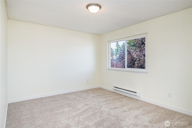 8823 Holly Dr Unit H207, Everett, WA 98208 - carpeted spare room featuring a baseboard heating unit, a textured ceiling, and baseboards