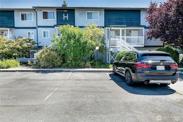 8823 Holly Dr Unit H207, Everett, WA 98208 - view of building exterior featuring uncovered parking and stairs