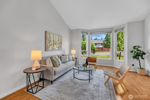 10704 25th Pl NE, Lake Stevens, WA 98258 - living room featuring baseboards, wood finished floors, and vaulted ceiling