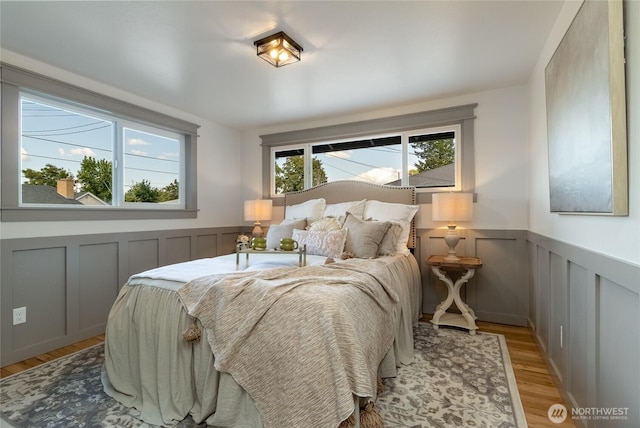 1328 Dakota St, Walla Walla, WA 99362 - bedroom featuring light wood-style flooring, a decorative wall, and a wainscoted wall