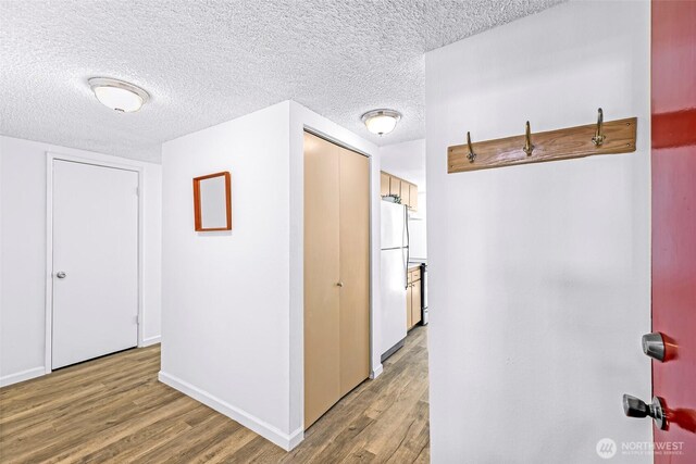 1338 Orleans St, Bellingham, WA 98229 - hall featuring wood finished floors, a textured ceiling, and baseboards