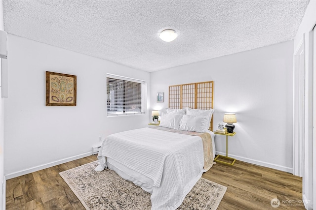 1338 Orleans St, Bellingham, WA 98229 - bedroom with a textured ceiling, wood finished floors, baseboards, and a baseboard heating unit