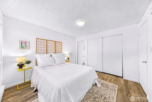 1338 Orleans St, Bellingham, WA 98229 - bedroom featuring wood finished floors, a closet, a textured ceiling, and baseboards