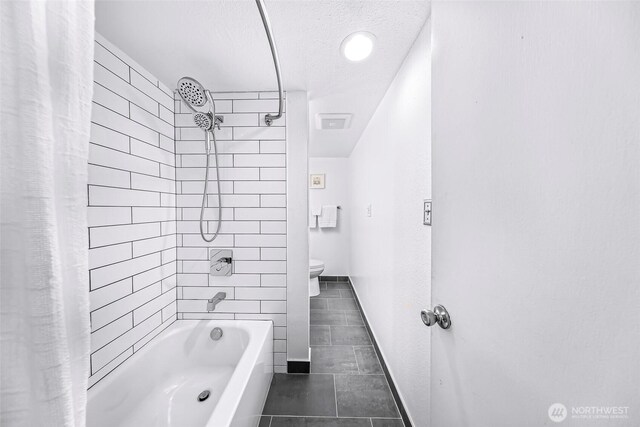 1338 Orleans St, Bellingham, WA 98229 - bathroom with toilet, shower / bath combo with shower curtain, tile patterned flooring, a textured ceiling, and baseboards