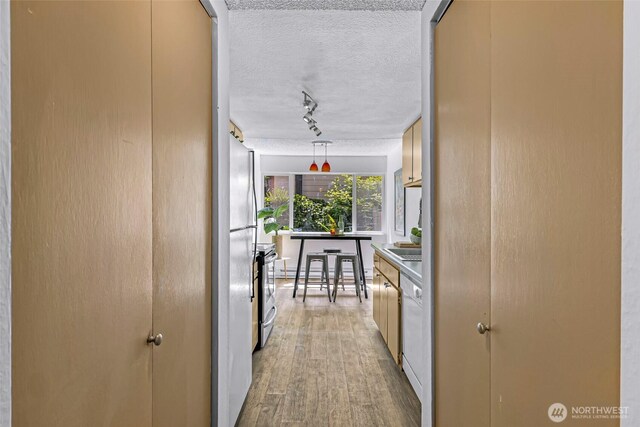 1338 Orleans St, Bellingham, WA 98229 - hall with a textured ceiling, track lighting, and light wood finished floors