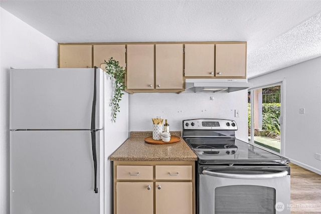 1338 Orleans St, Bellingham, WA 98229 - kitchen with freestanding refrigerator, stainless steel electric range, under cabinet range hood, a textured ceiling, and cream cabinetry