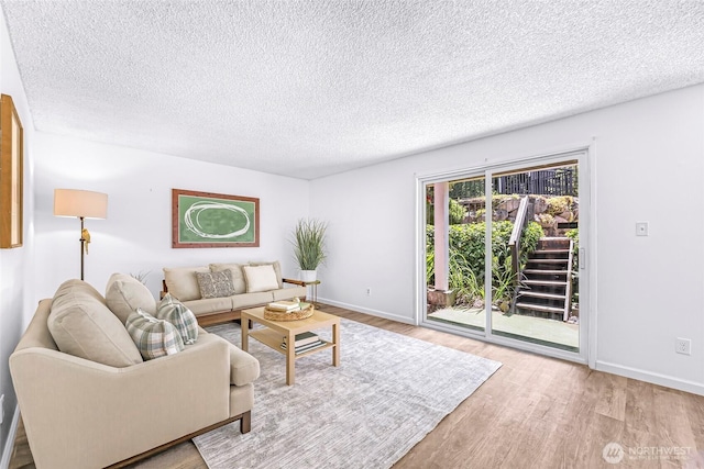 1338 Orleans St, Bellingham, WA 98229 - living area with wood finished floors, a textured ceiling, and baseboards