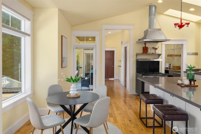 11744 NE Sand Point Way, Seattle, WA 98125 - dining room featuring healthy amount of natural light, lofted ceiling, light wood finished floors, baseboards, and recessed lighting