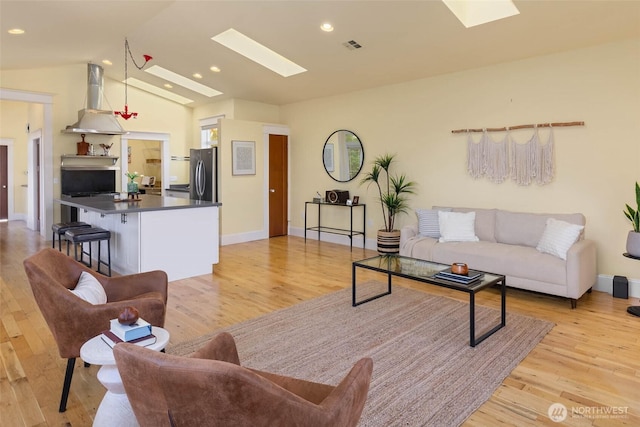 11744 NE Sand Point Way, Seattle, WA 98125 - living room with a skylight, light wood-type flooring, lofted ceiling, and recessed lighting