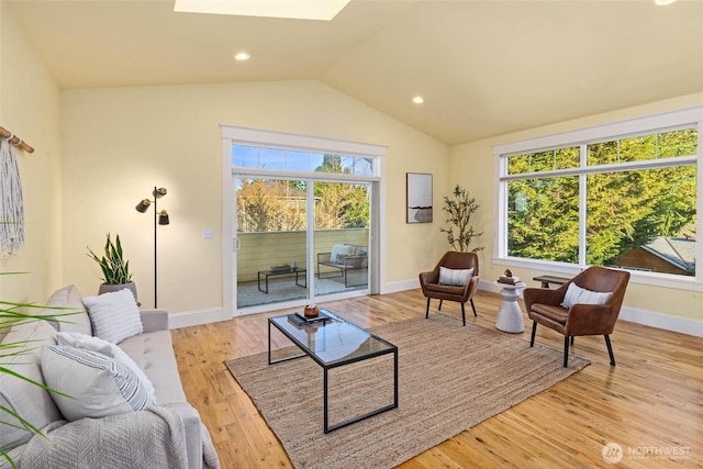 11744 NE Sand Point Way, Seattle, WA 98125 - living room featuring vaulted ceiling, baseboards, a skylight, and light wood-type flooring