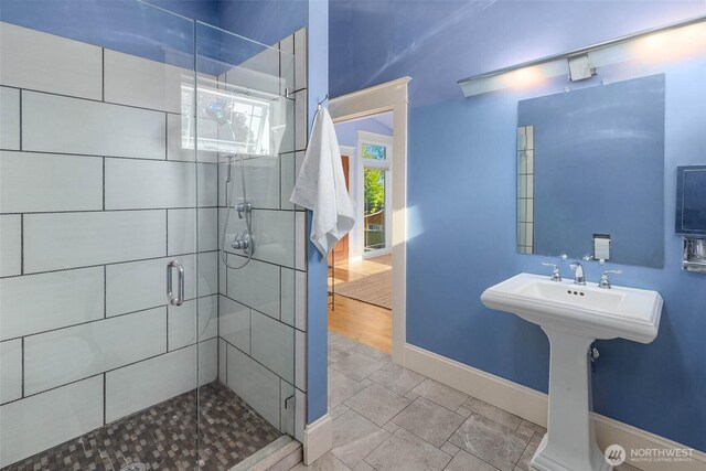 11744 NE Sand Point Way, Seattle, WA 98125 - bathroom with a stall shower and baseboards