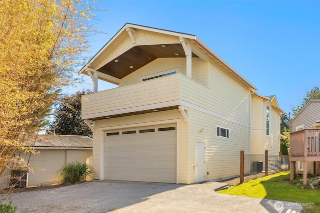 11744 NE Sand Point Way, Seattle, WA 98125 - view of side of property featuring cooling unit, driveway, and a garage